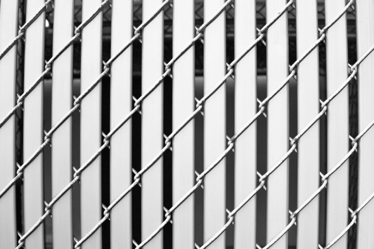 Detailed close-up of a metal wire fence with a striped pattern, emphasizing its minimalistic design.